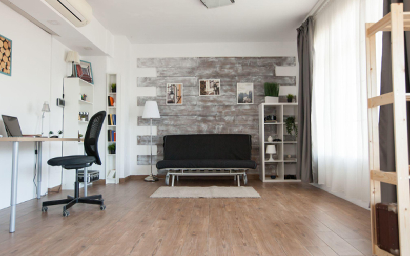 Modern living room with stylish furniture and wood-look flooring in a comfortable apartment.