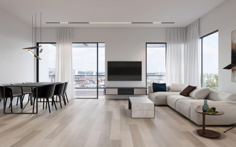 A modern living room with a stylish blend of beige sofas and an elegant LVT floor.