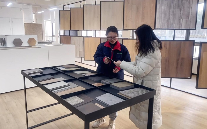 A customer selects flooring samples in the showroom.