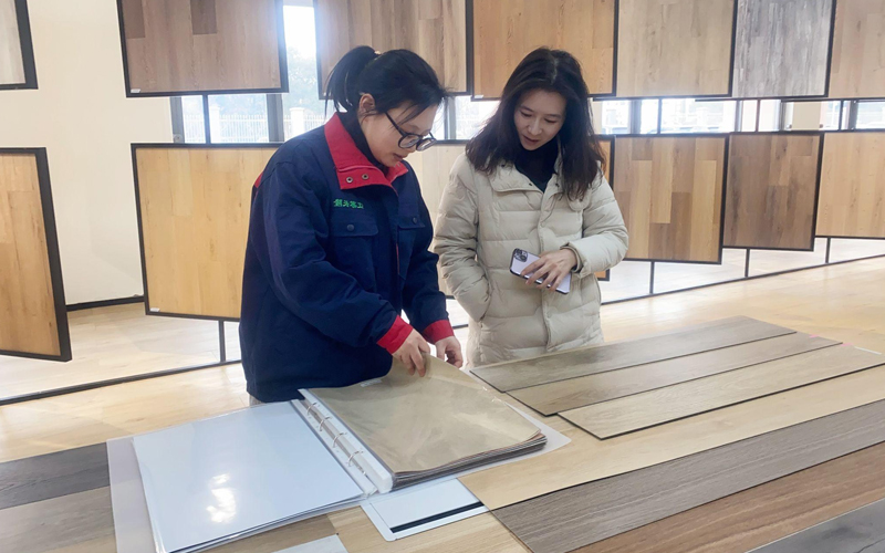 Customer selecting flooring styles and colors in a flooring showroom