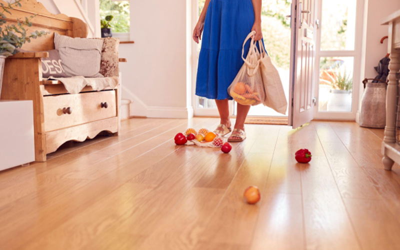 A woman accidentally dropped the fresh produce on the LVT floor.