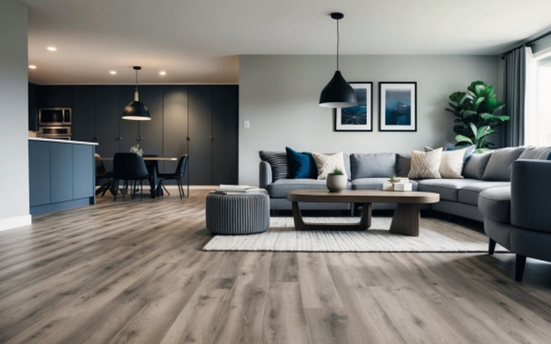 The living room features a modern design with dark wood-grain LVT flooring.