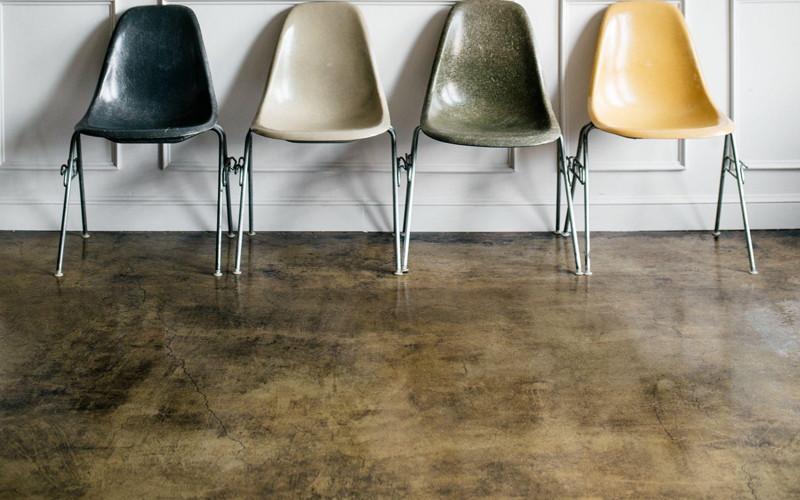 Chairs in a living room with industrial-style flooring