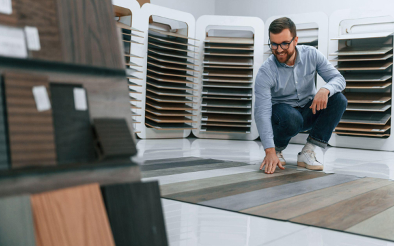 A man is choosing the style of LVT floors.
