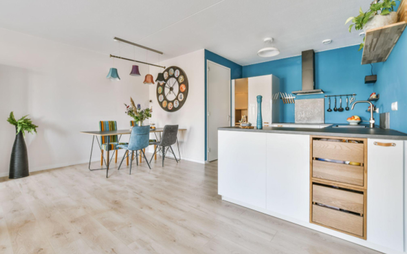 Kitchen with contemporary appliances, warm light colored LVT flooring. 