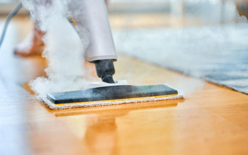 Cleaning the LVT flooring with a steam cleaner.
