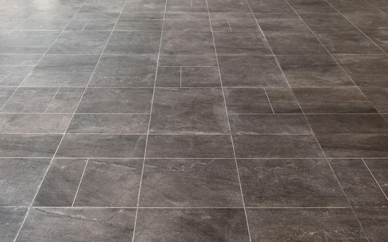 Modern gray stone tile flooring with rectangular pattern and light grout lines