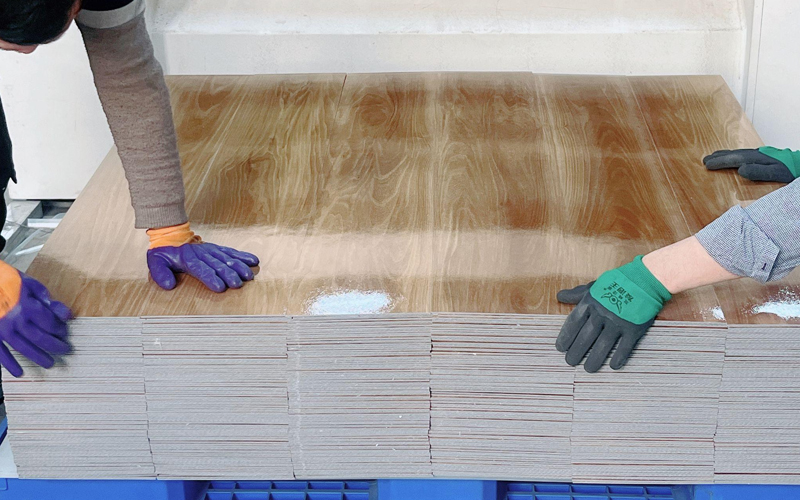 Newly cut vinyl flooring panels with clean, precise edges.