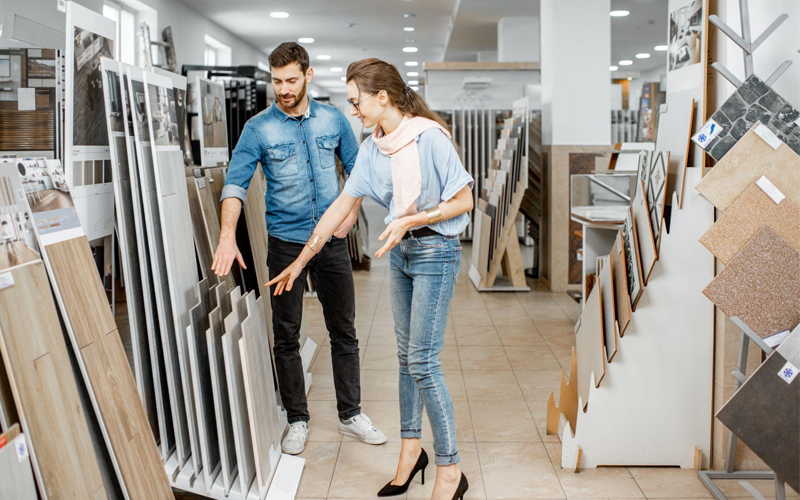 Couple choosing ceramic tiles in the flooring shop